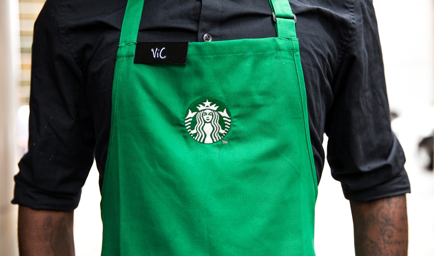Photo of Starbucks employee wearing a branded apron.
