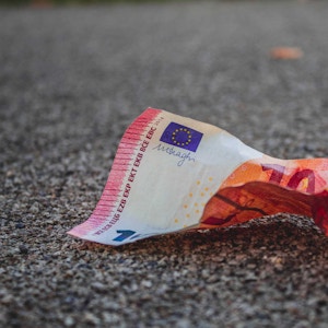 A piece of crumbled 10 euro cash on the ground